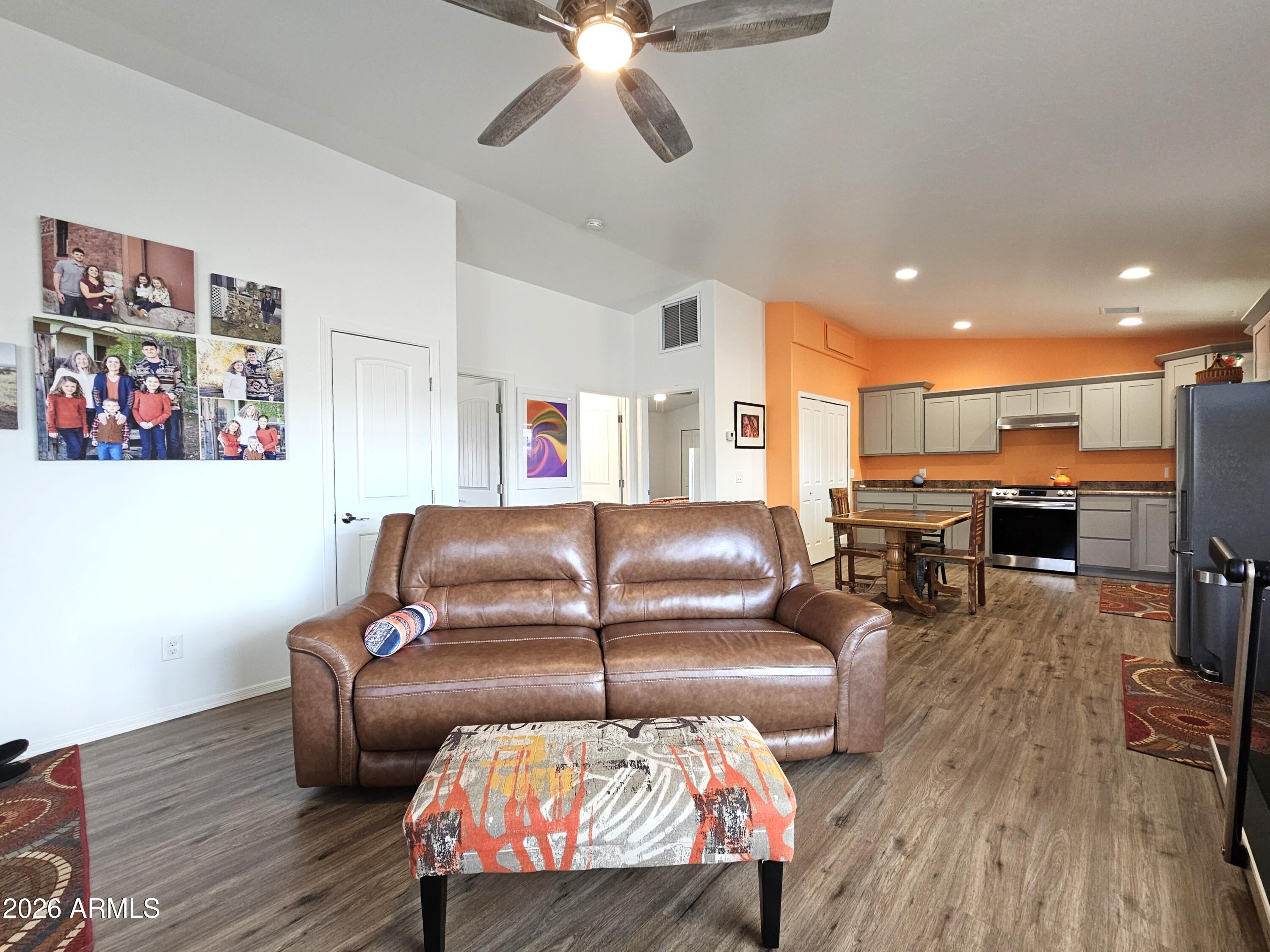5705 South Wild Rose Road Hereford, AZ 85615 - Photo 32 of 39 a living room with furniture kitchen view and a wooden floor
