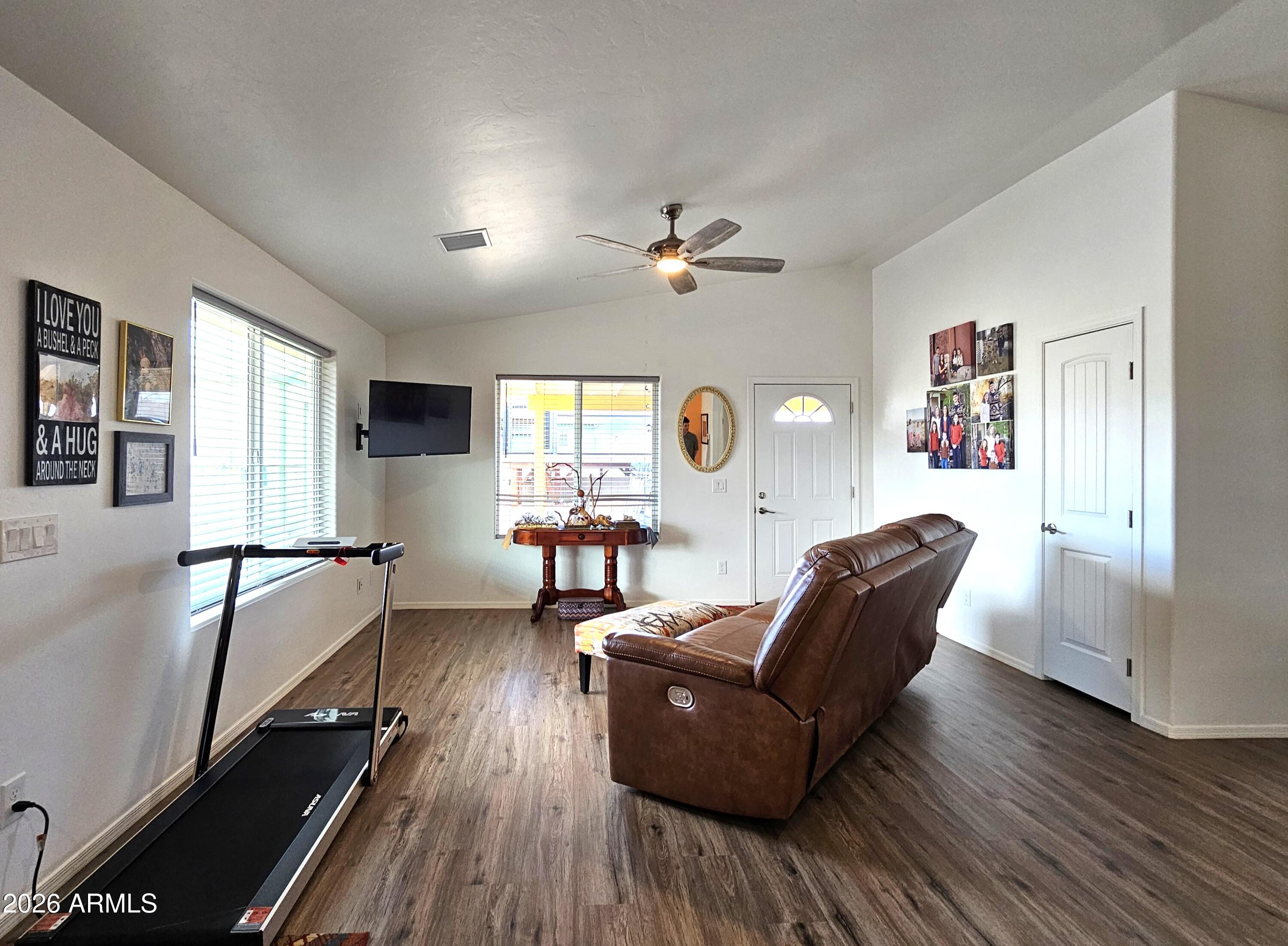 5705 South Wild Rose Road Hereford, AZ 85615 - Photo 33 of 39 a living room with furniture and a wooden floor
