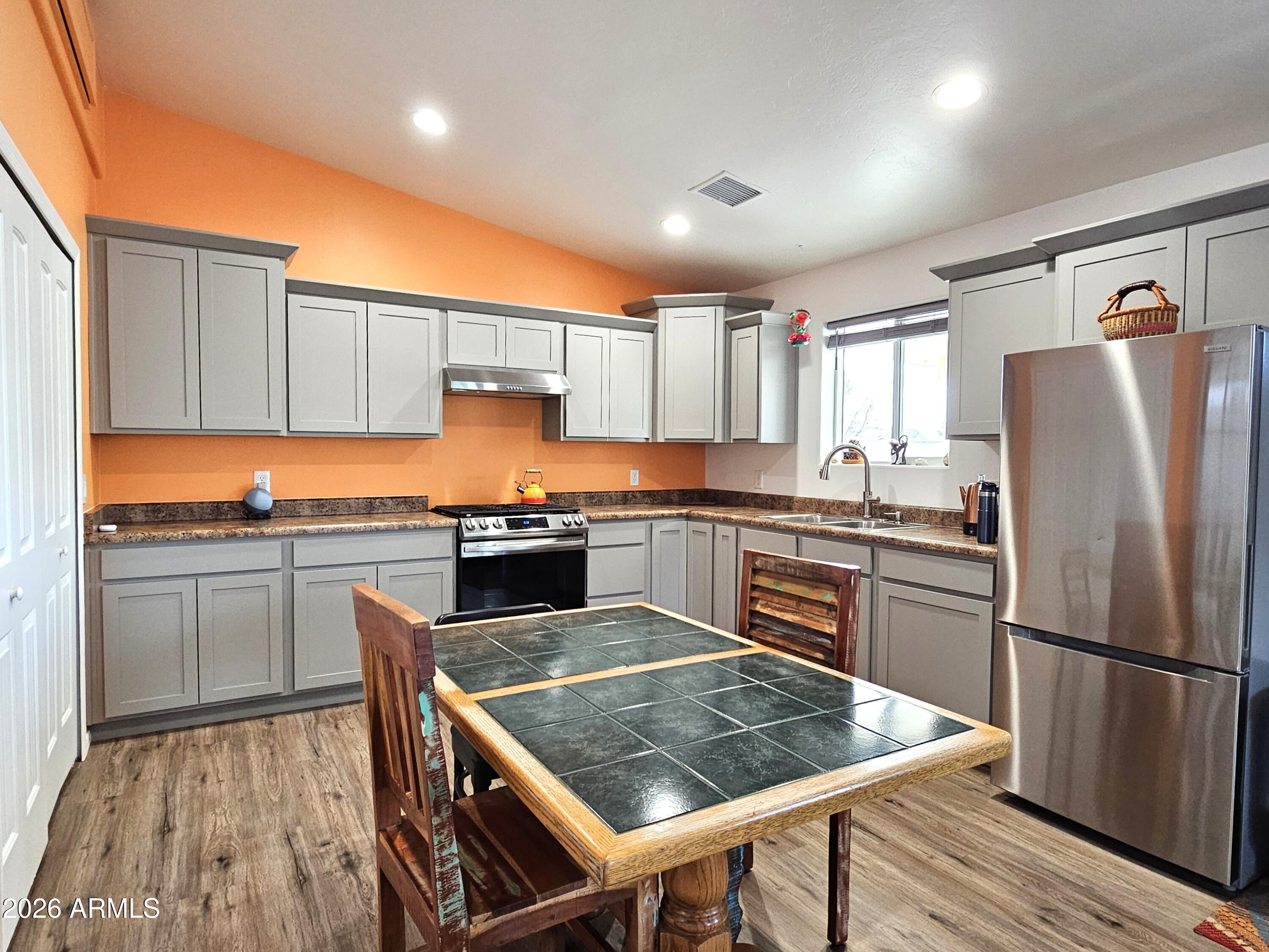 5705 South Wild Rose Road Hereford, AZ 85615 - Photo 34 of 39 a kitchen with granite countertop a refrigerator stove top oven and sink
