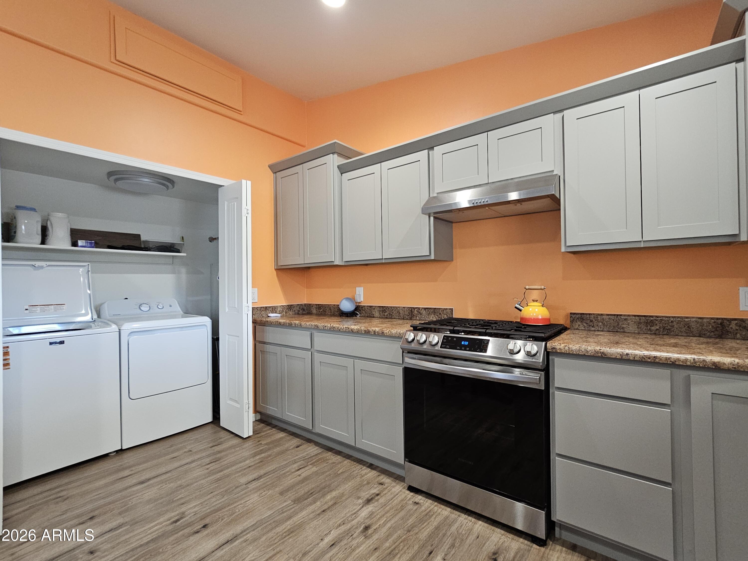 5705 South Wild Rose Road Hereford, AZ 85615 - Photo 35 of 39 a kitchen with a stove top oven sink and cabinets