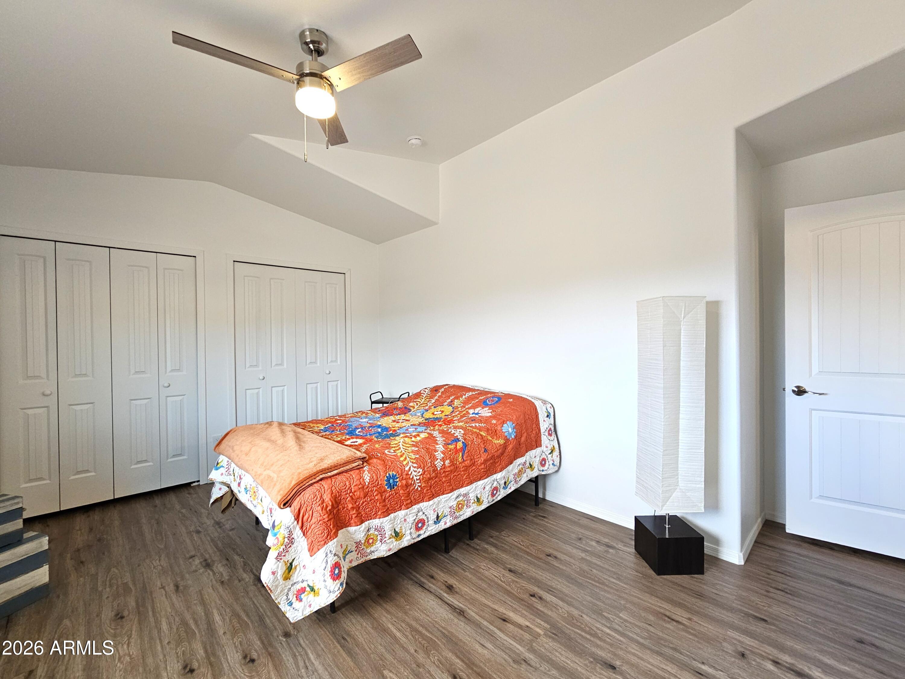 5705 South Wild Rose Road Hereford, AZ 85615 - Photo 36 of 39 a bedroom with a bed and wooden floor