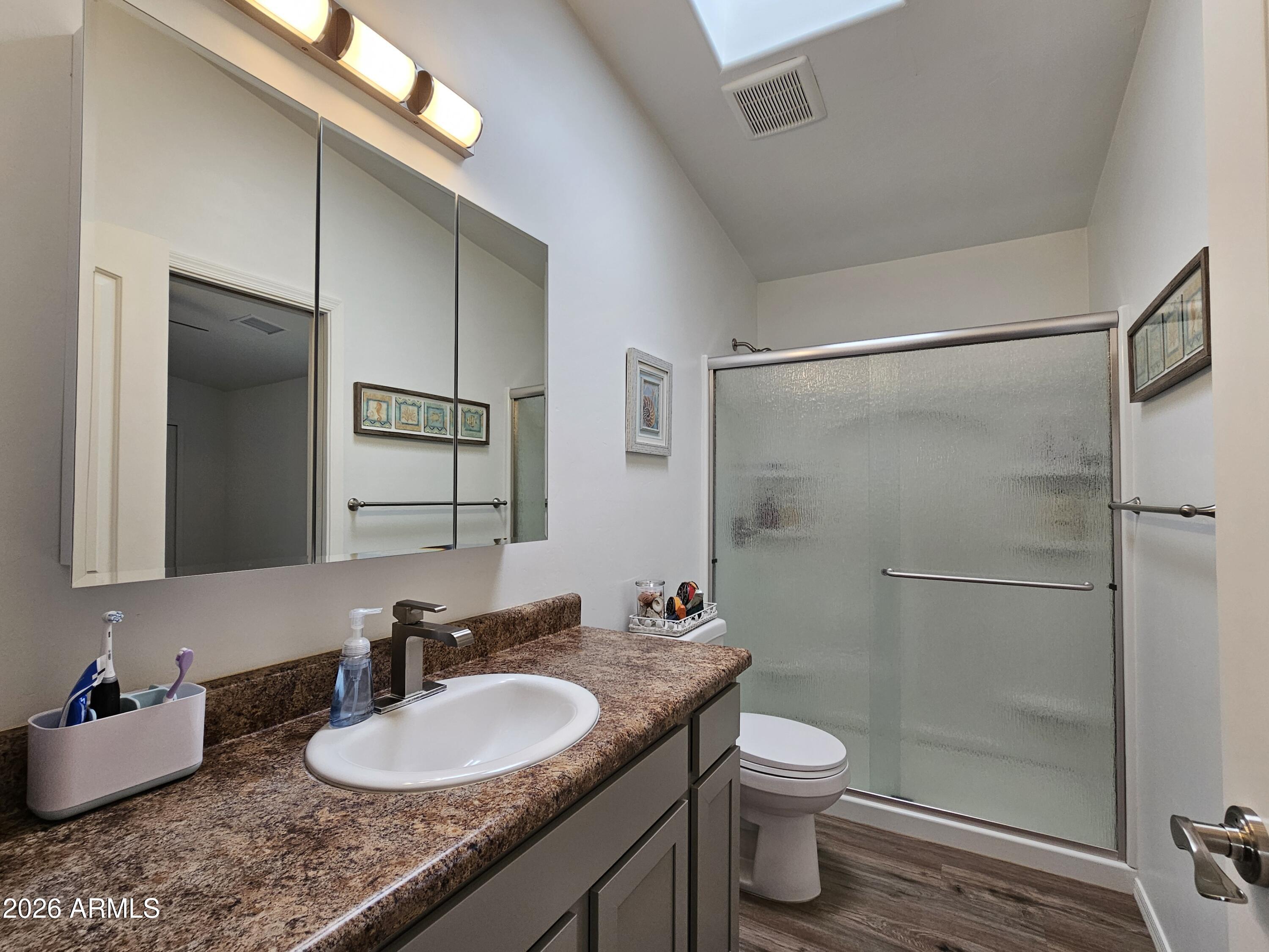 5705 South Wild Rose Road Hereford, AZ 85615 - Photo 38 of 39 a bathroom with a granite countertop sink toilet and shower