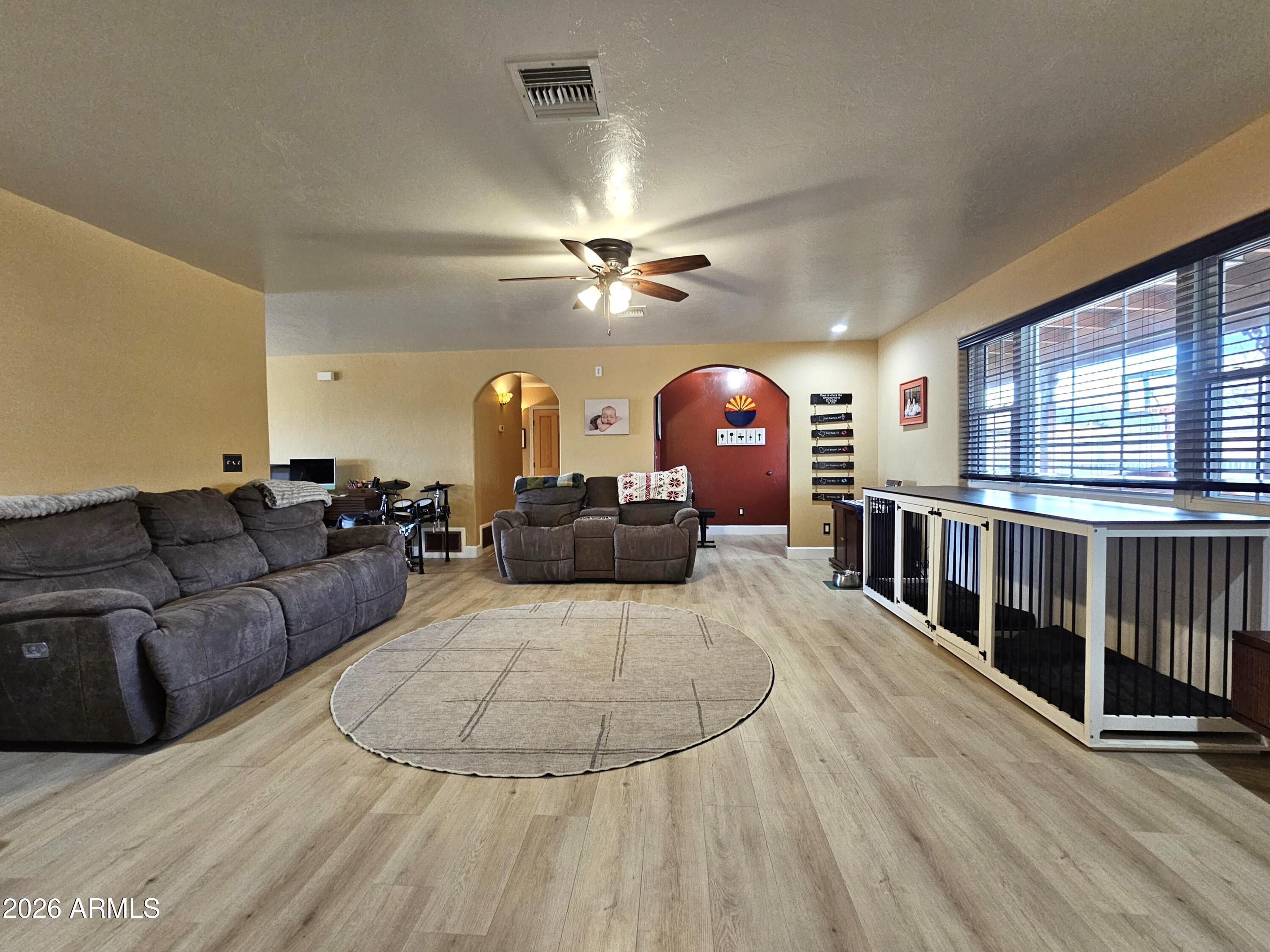 5705 South Wild Rose Road Hereford, AZ 85615 - Photo 8 of 39 a living room with furniture a chandelier and a rug