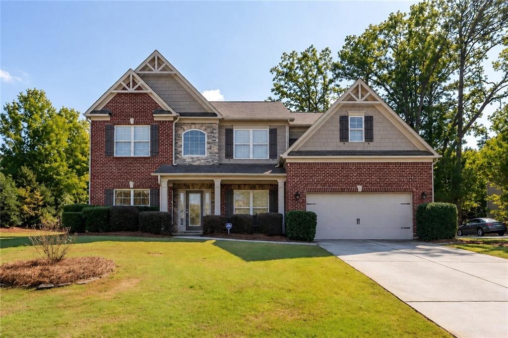 3880 Courson Street Marietta, GA 30066 - Photo 1 of 45 a front view of a house with a yard garage and a tree