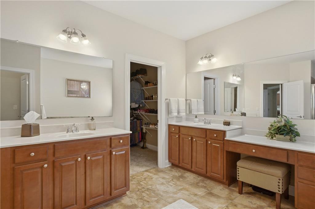 3880 Courson Street Marietta, GA 30066 - Photo 18 of 45 a spacious bathroom with a double vanity sink a large mirror and a bathtub