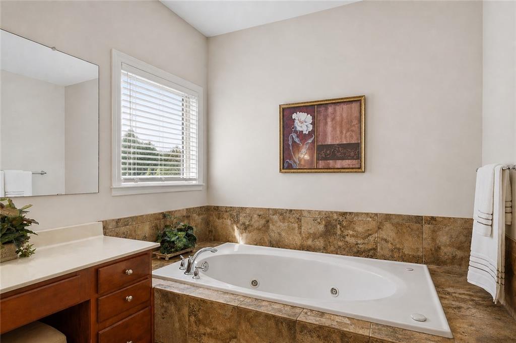 3880 Courson Street Marietta, GA 30066 - Photo 19 of 45 a bathroom with a tub a sink and a window