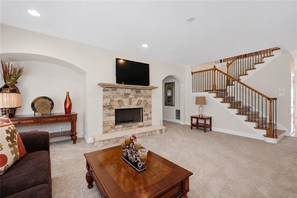 3880 Courson Street Marietta, GA 30066 - Photo 4 of 45 a living room with furniture a flat screen tv and a fireplace