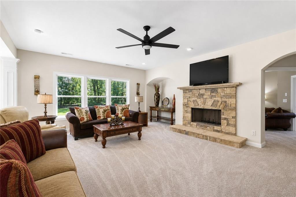 3880 Courson Street Marietta, GA 30066 - Photo 5 of 45 a living room with furniture a fireplace and a flat screen tv