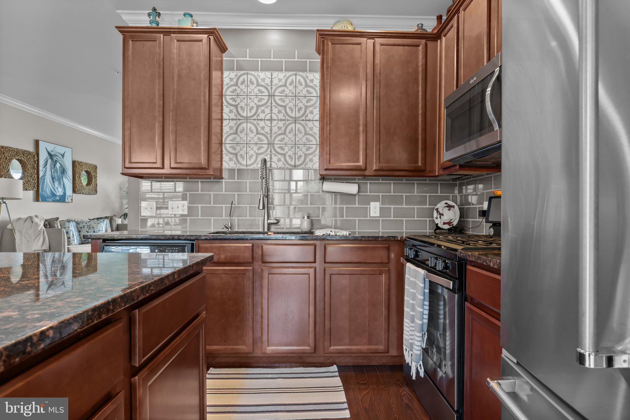 3799 Jacob Stout Road, Unit 9 Doylestown, PA 18902 - Photo 14 of 42 a kitchen with stainless steel appliances granite countertop a sink stove and cabinets