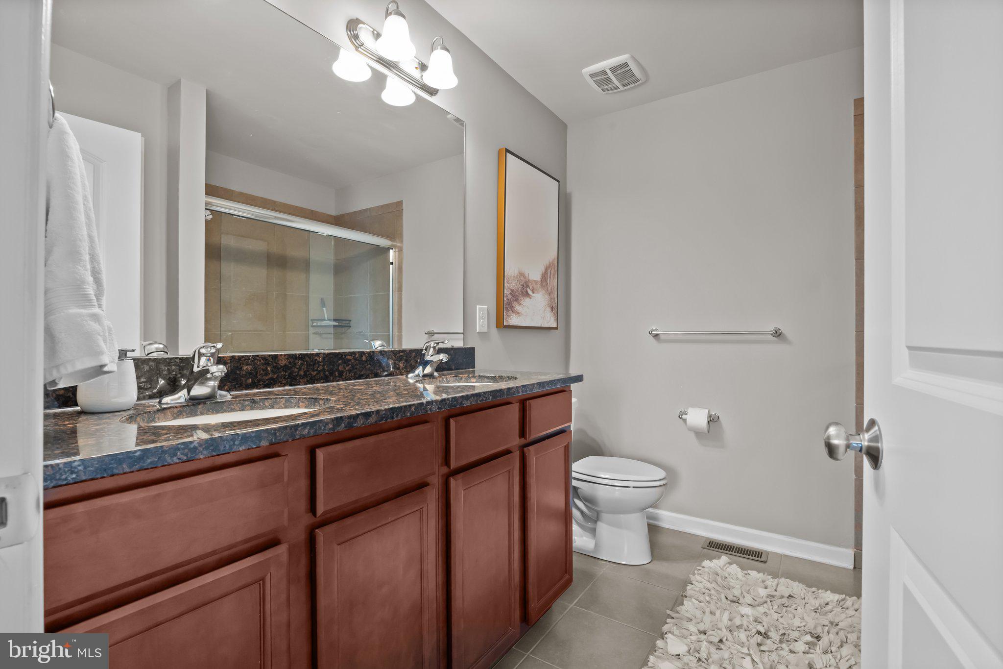 3799 Jacob Stout Road, Unit 9 Doylestown, PA 18902 - Photo 21 of 42 a bathroom with a double vanity sink toilet and a mirror