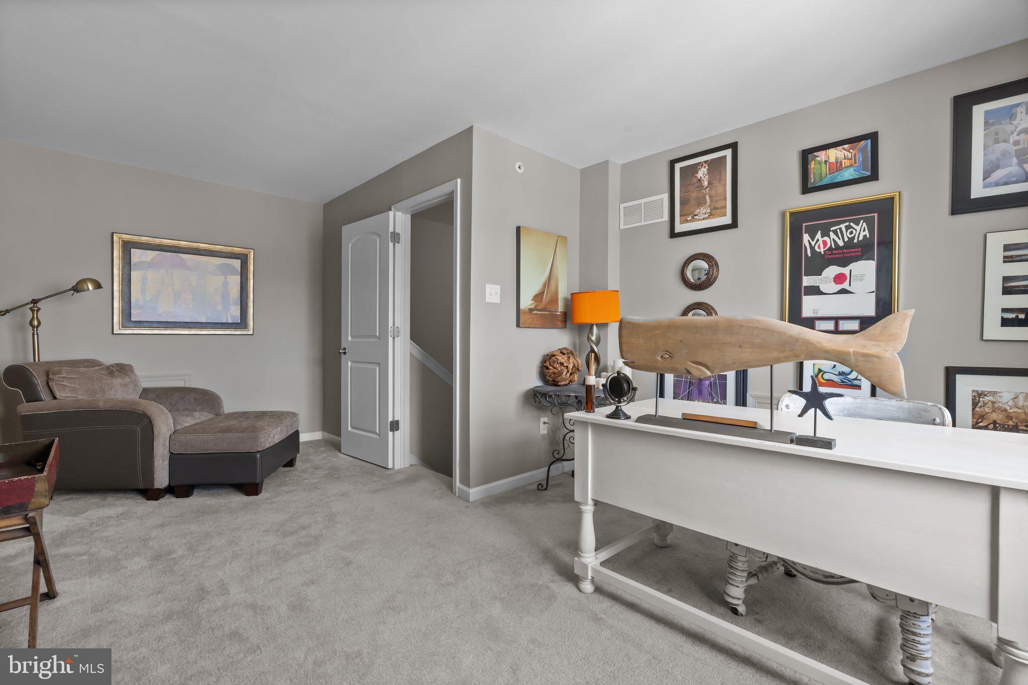 3799 Jacob Stout Road, Unit 9 Doylestown, PA 18902 - Photo 28 of 42 a living room with furniture and paintings on the wall