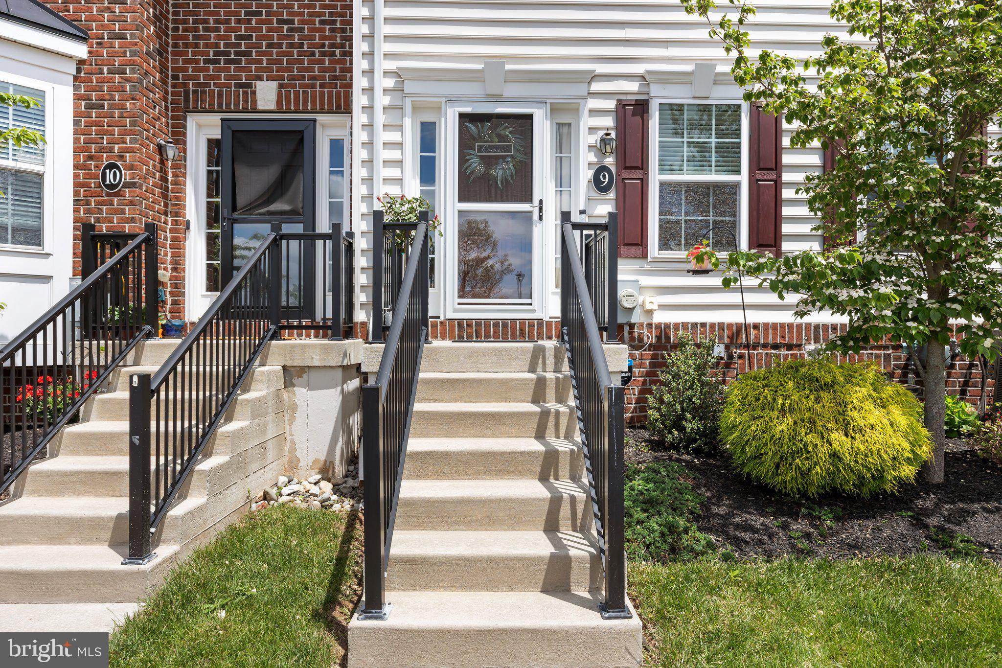 3799 Jacob Stout Road, Unit 9 Doylestown, PA 18902 - Photo 4 of 42 a view of a house with a large windows and flower plants with wooden fence