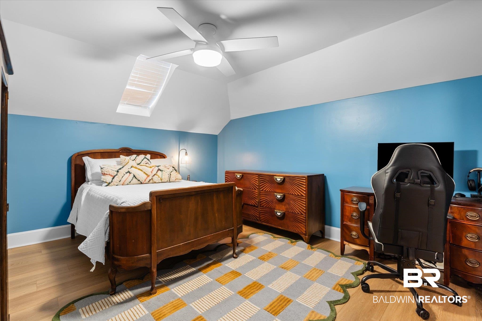 1210 Government Street Mobile, AL 36604 - Photo 22 of 37 Bedroom featuring vaulted ceiling with skylight, hardwood / wood-style flooring, and ceiling fan
