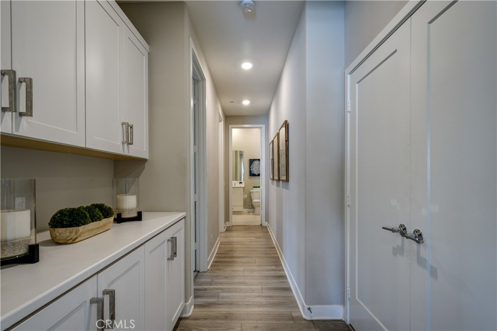 413 Transport Tustin, CA 92782 - Photo 21 of 47 a view of a hallway with wooden floor and cabinets