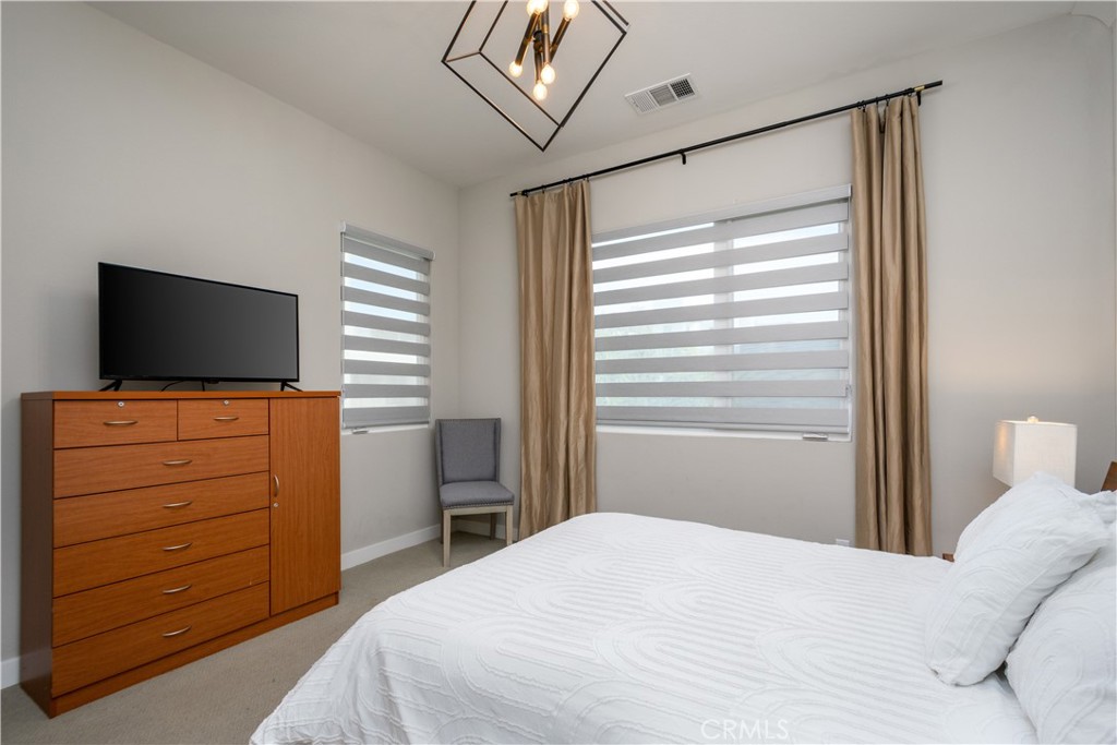 413 Transport Tustin, CA 92782 - Photo 22 of 49 a bedroom with a bed and a flat screen tv