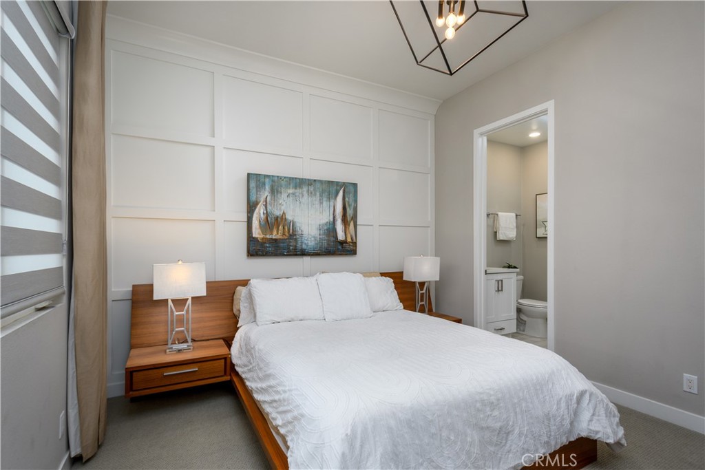 413 Transport Tustin, CA 92782 - Photo 23 of 49 a bedroom with a bed and a chandelier