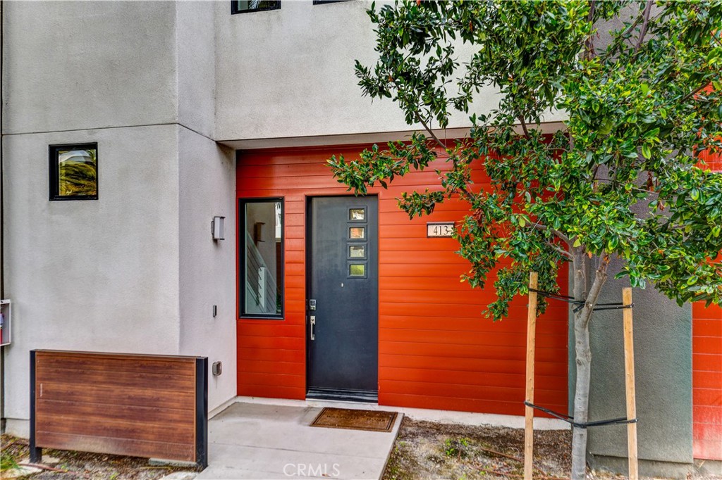 413 Transport Tustin, CA 92782 - Photo 39 of 49 a front view of a house with a tree