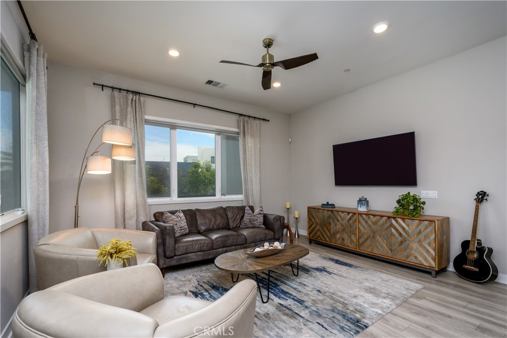 413 Transport Tustin, CA 92782 - Photo 4 of 49 a living room with furniture and a flat screen tv