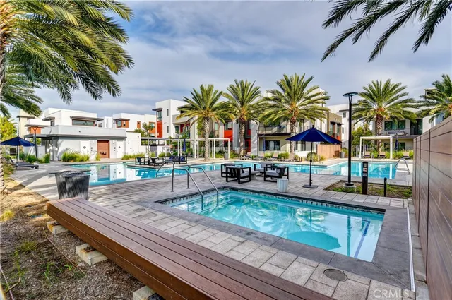 a backyard of a house with barbeque oven table and chairs