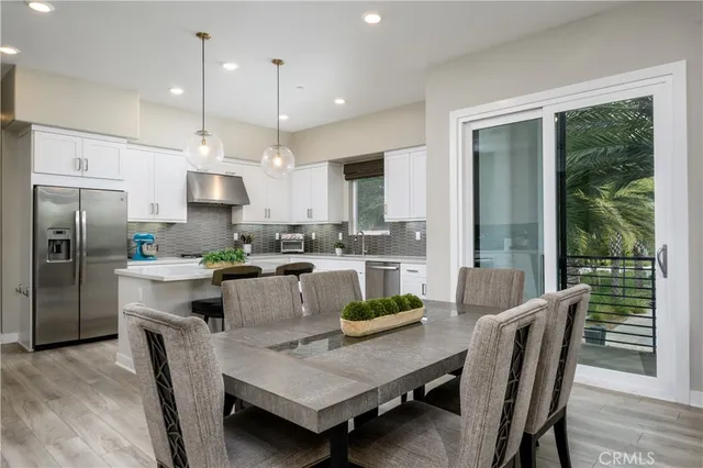 a kitchen with counter space dining table and stainless steel appliances