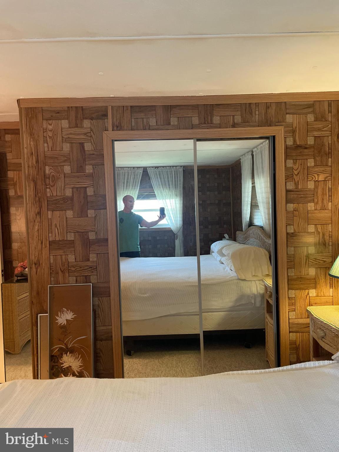 131-25 Priest Boulevard Rio Grande, NJ 08242 - Photo 22 of 35 a bedroom with a bed and a mirror