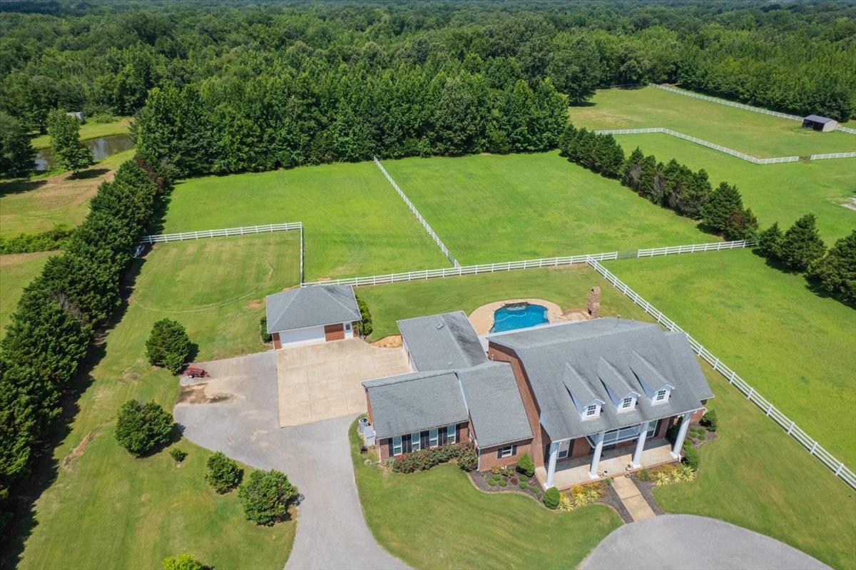 740 Frazier Road Rossville, TN 38066 - Photo 6 of 40 Expansive property featuring a swimming pool, multiple fenced green pastures, and a detached two-car garage