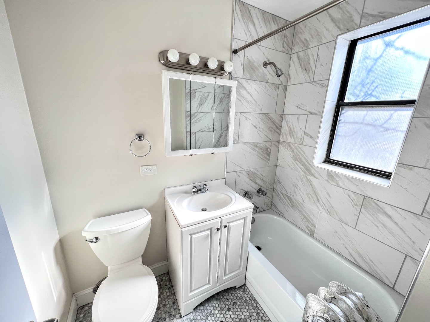 3933 North Clarendon Avenue, Unit 507 Chicago, IL 60613 - Photo 11 of 12 a bathroom with a toilet sink and mirror