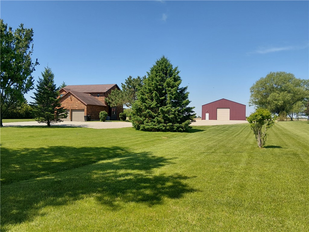 646 North Rangeline Road Pleasant Hill, OH 45359 - Photo 2 of 11 Discover this well-maintained brick residence and complementary outbuilding on a generous, verdant parcel.