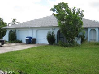 7460 Pebble Beach Road Fort Myers, FL 33967 - Photo 1 of 5 a front view of a house with swing and plants