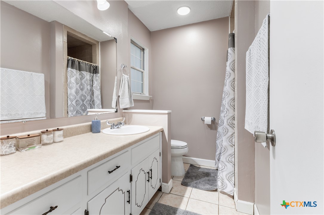 144 Jordan Loop Nolanville, TX 76559 - Photo 10 of 20 a bathroom with a double vanity sink toilet and shower