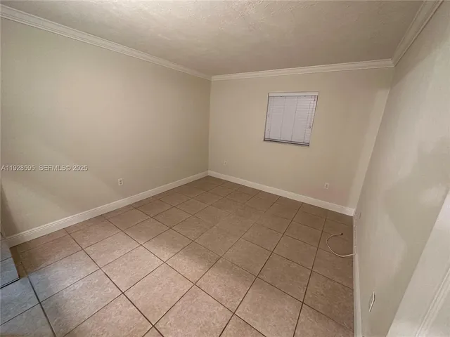 a view of an empty room and a bathroom
