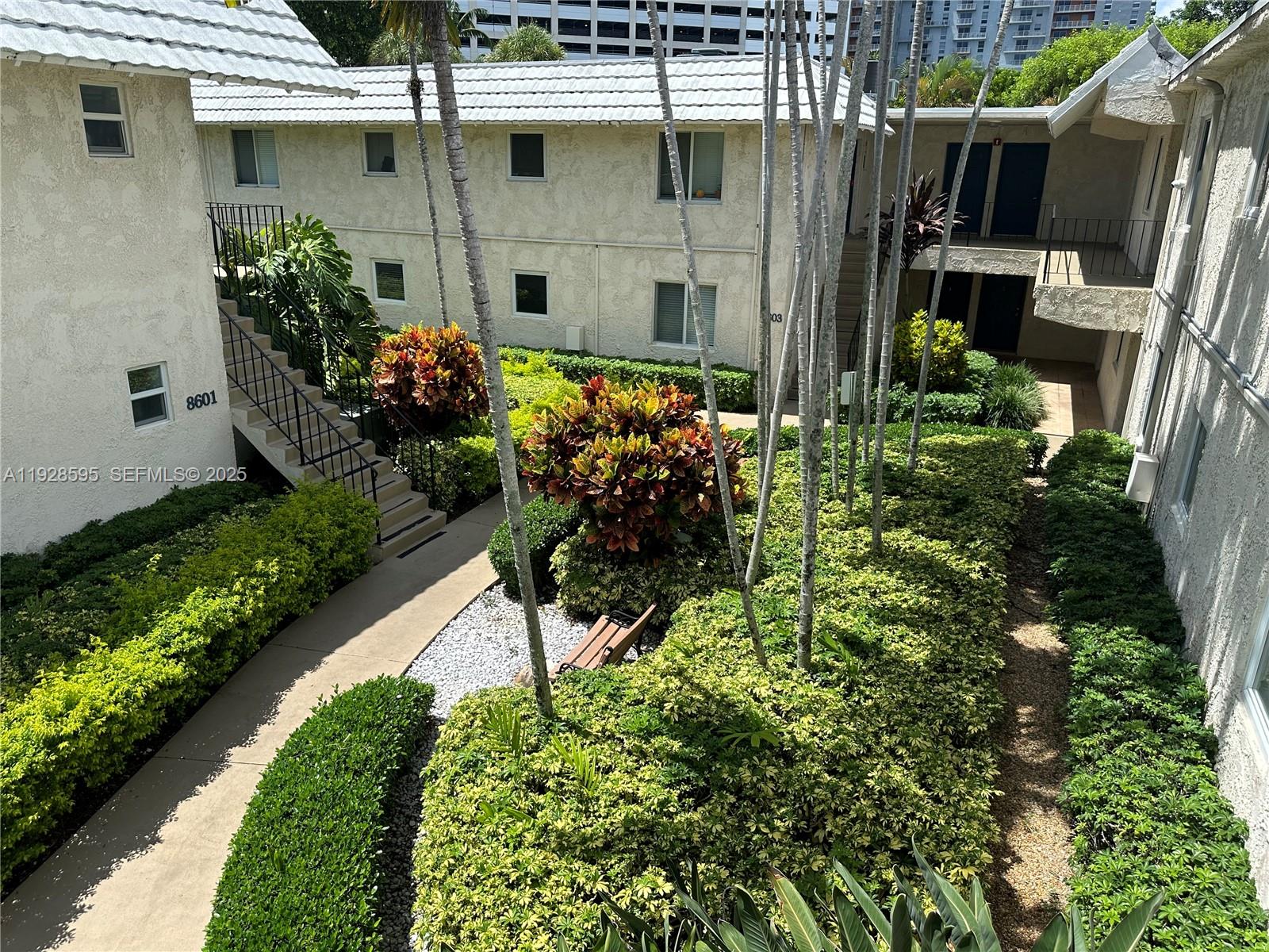 8603 Southwest 68th Court, Unit 26 Pinecrest, FL 33156 - Photo 10 of 13 a view of a backyard with plants
