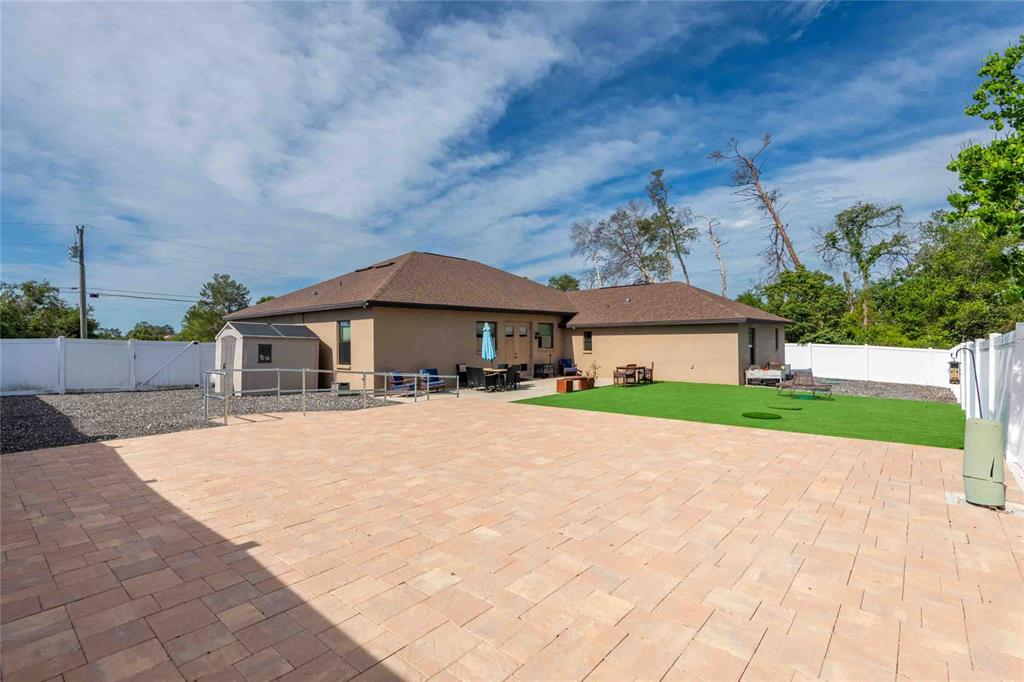 Undisclosed Address Spring Hill, FL 34608 - Photo 24 of 39 a front view of a house with a yard and garage