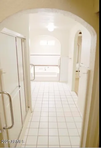 a bathroom with a tub sink and a mirror