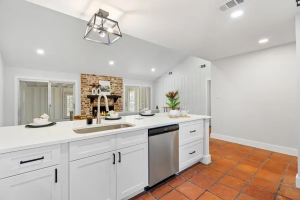 a spacious bathroom with a granite countertop sink a mirror and a vanity