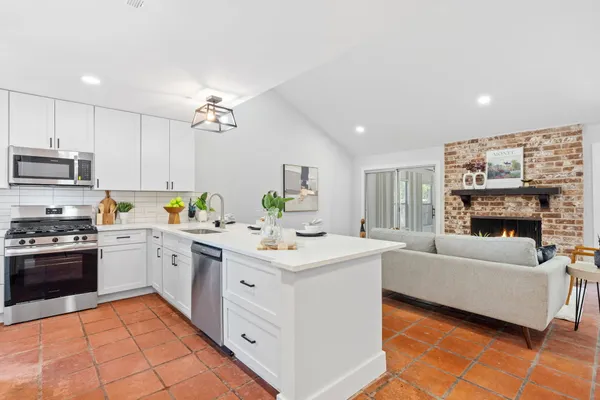 a kitchen with a sink stove and cabinets