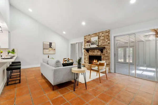 a living room with furniture and kitchen view