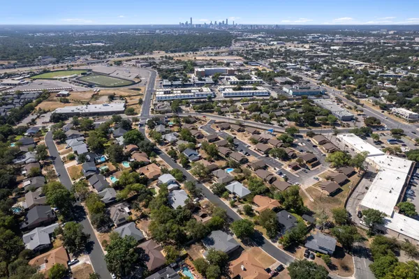 an aerial view of a house with a yard and garden