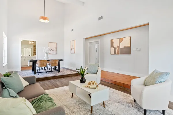 a living room with furniture and wooden floor