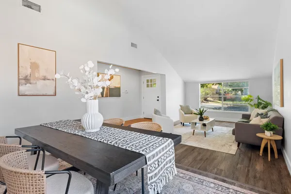 a living room with furniture a window and a table