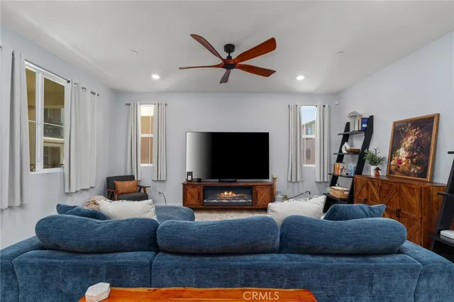 a living room with furniture and a flat screen tv