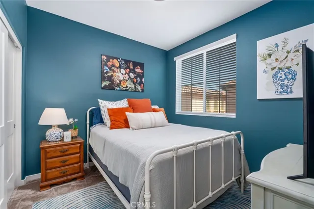 a bedroom with bed and a window