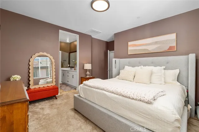 a bedroom with a bed couch and window