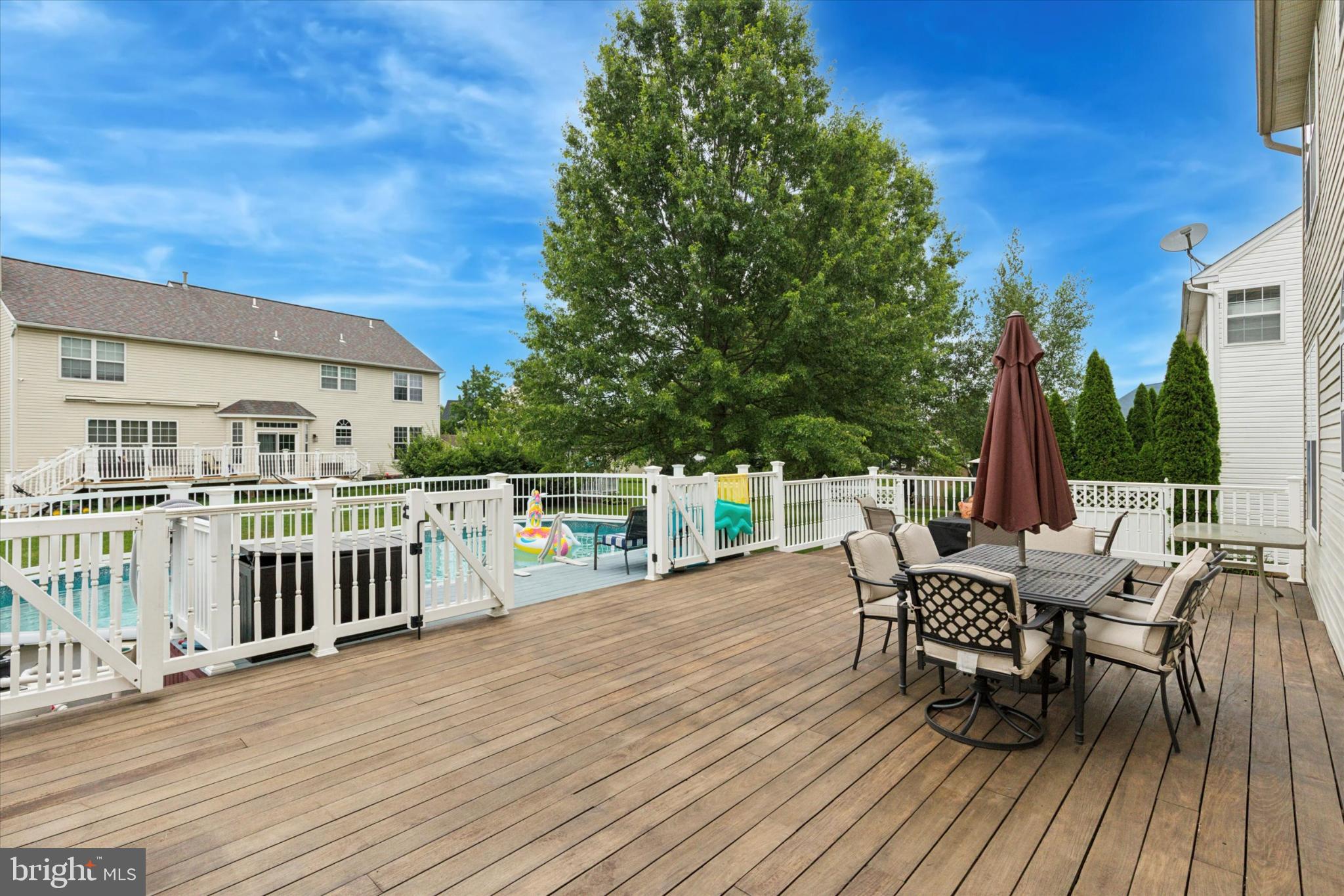 227 Beech Lane Perkasie, PA 18944 - Photo 4 of 34 Spacious deck overlooking a serene pool area.