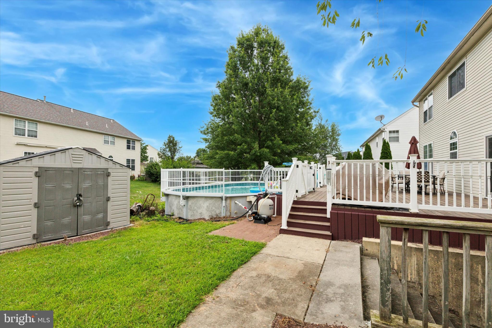 227 Beech Lane Perkasie, PA 18944 - Photo 5 of 34 Serene backyard oasis with pool and greenery.