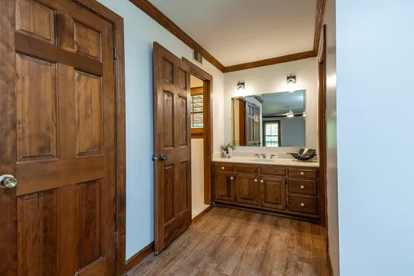 a view of empty room with wooden floor