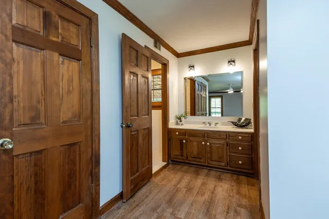a view of empty room with wooden floor