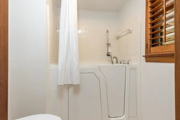 a view of an entryway with wooden floor and door
