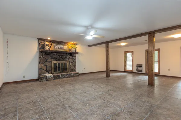 an empty room with windows and pillars in it