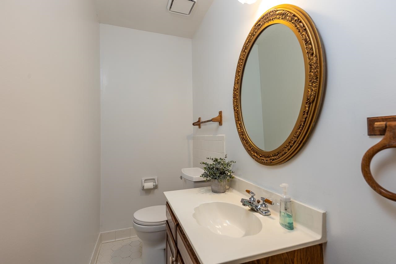 900 Center Point Drive Mason, TN 38049 - Photo 30 of 36 a bathroom with a sink a toilet and a mirror